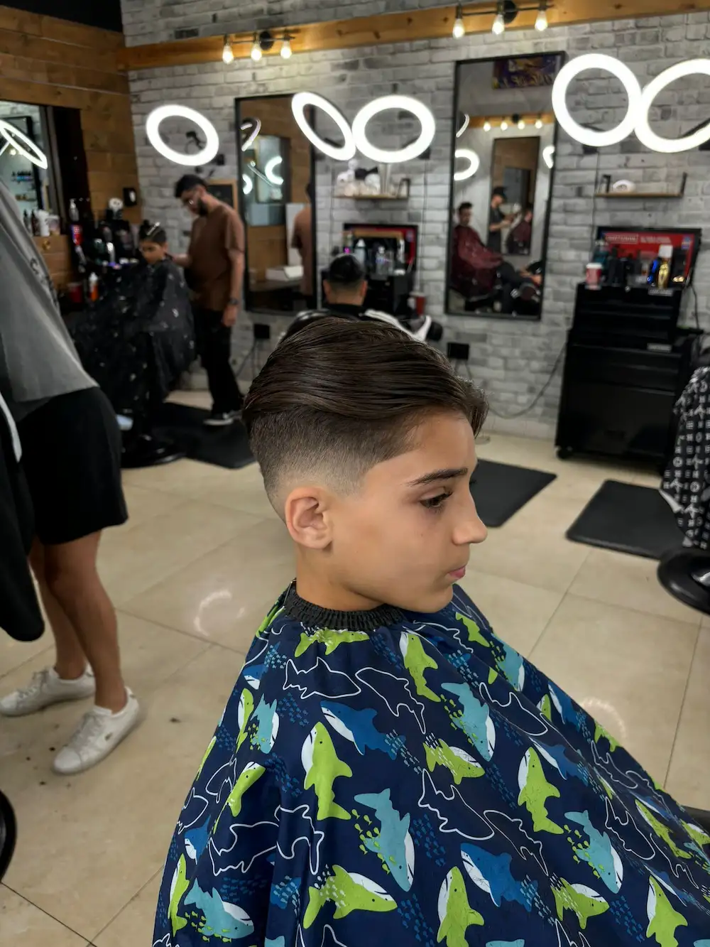 Young child sitting in the barber chair for a haircut